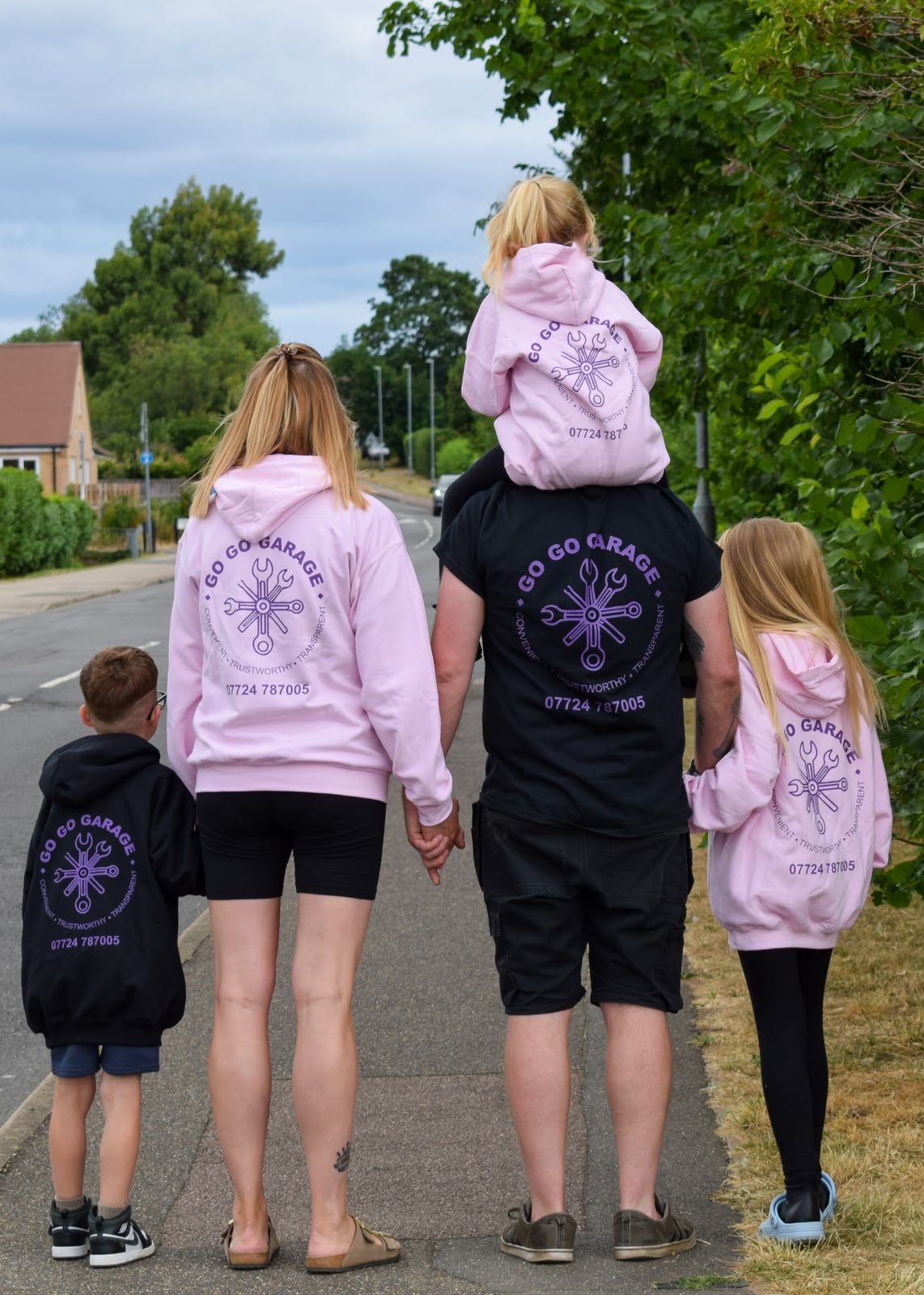 The Lee family walking together in Go Go Garage branded hoodies