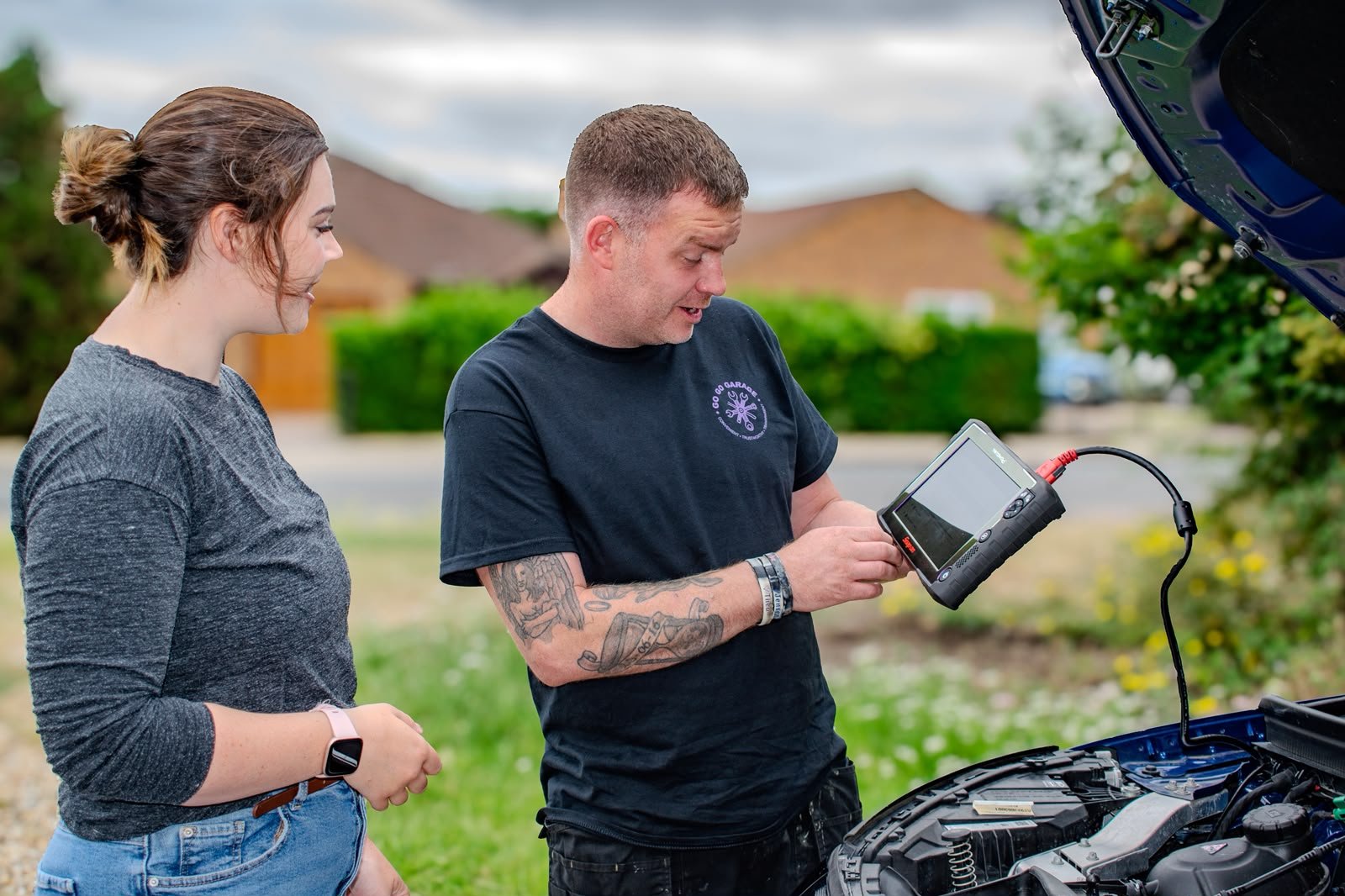 Tom showing a customer the diagnostic scan results on his tablet