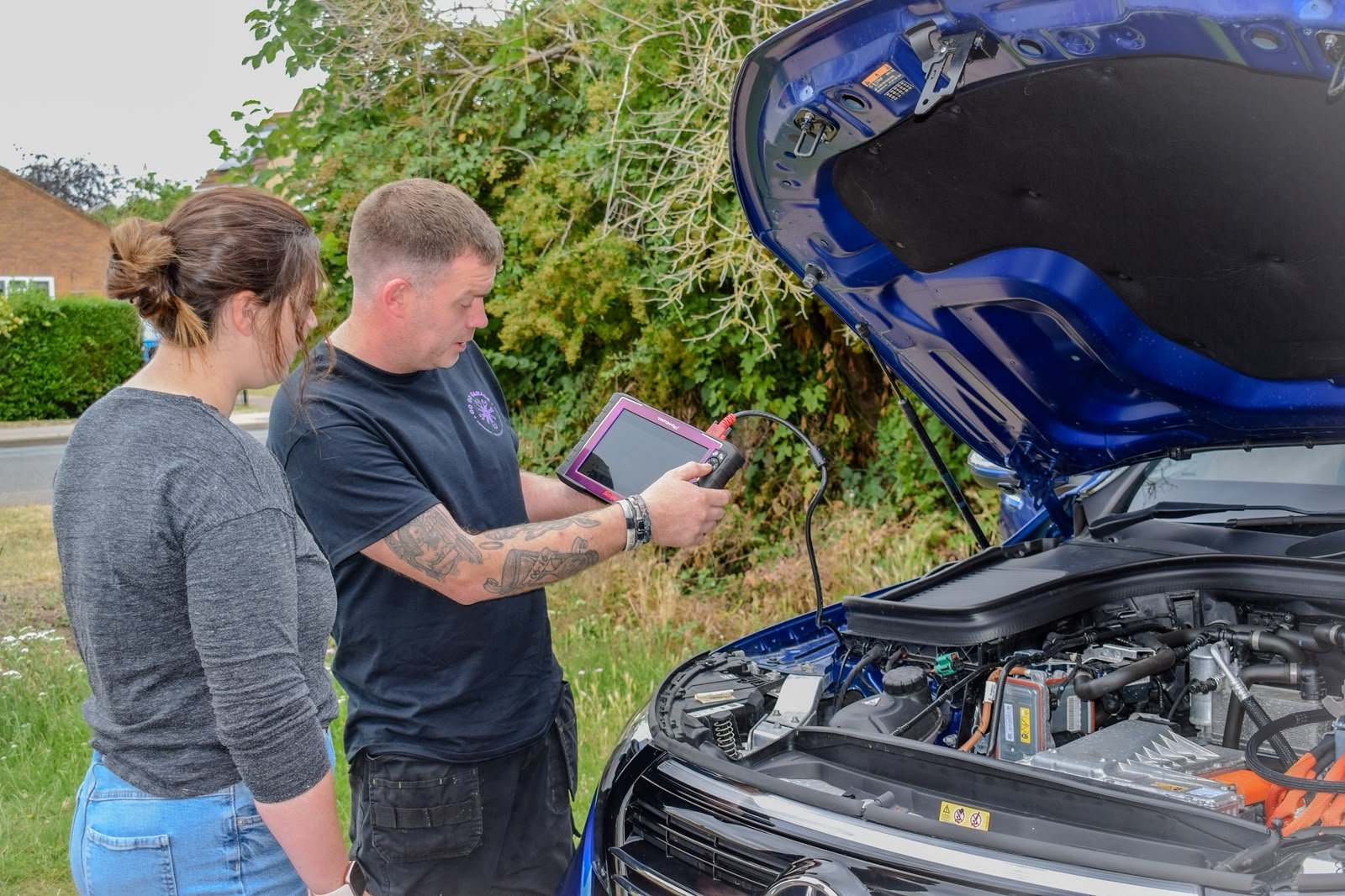 Tom running diagnostics on an electric Mercedes EQC with a customer